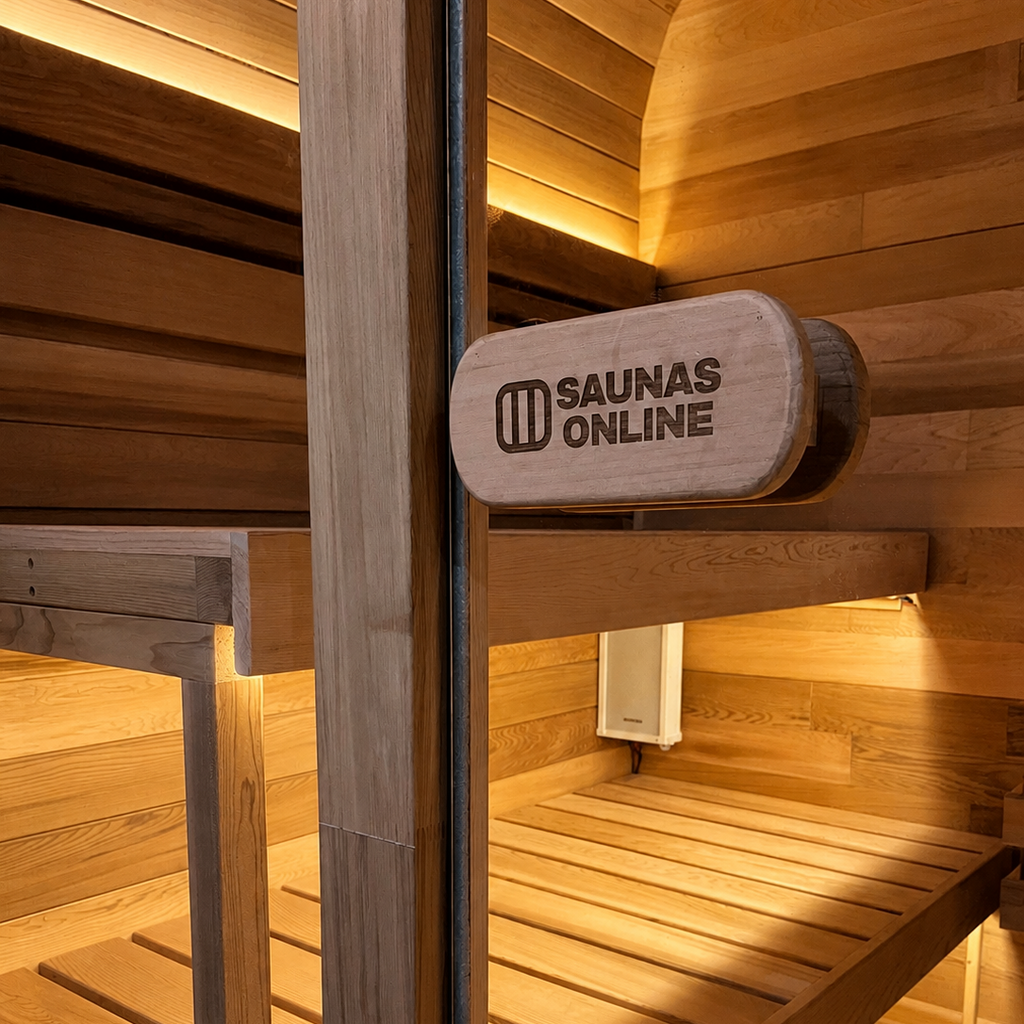 A wooden sauna interior with two tiers of wooden benches, warm ambient lighting, and a round wooden sign engraved with the brand name 'SAUNAS ONLINE'.